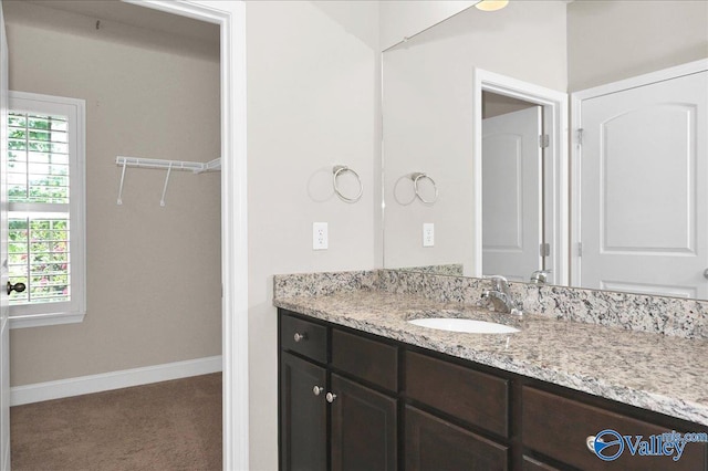 5 Leyland Dr, Huntsville, AL 35824 - bathroom with vanity, baseboards, and a walk in closet