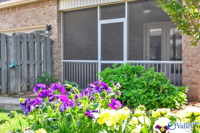 5 Leyland Dr, Huntsville, AL 35824 - view of property exterior with brick siding, fence, and a sunroom