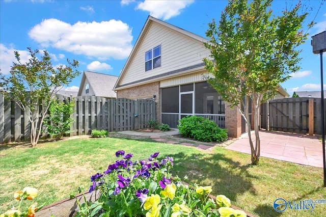 5 Leyland Dr, Huntsville, AL 35824 - rear view of house with brick siding, a gate, a sunroom, and a patio