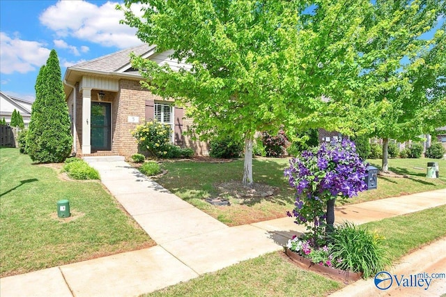 5 Leyland Dr, Huntsville, AL 35824 - view of front facade featuring a front lawn, brick siding, and roof with shingles