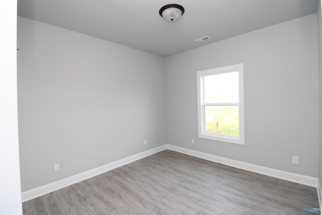 unfurnished room with hardwood / wood-style floors