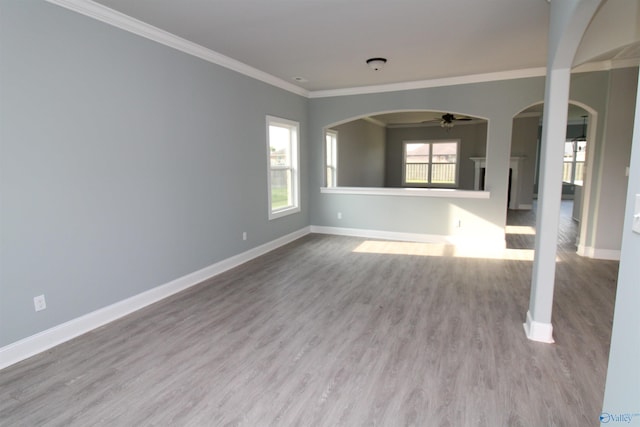 spare room featuring hardwood / wood-style flooring, ornamental molding, and ceiling fan