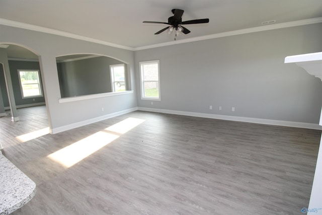 unfurnished room with ornamental molding, hardwood / wood-style floors, and ceiling fan