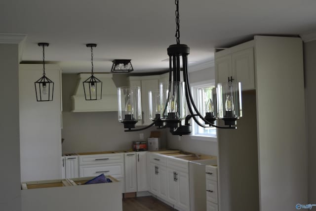 3720 Tidmore Bend Rd, Gadsden, AL 35901 - kitchen with crown molding, white cabinetry, hanging light fixtures, dark wood-type flooring, and light countertops