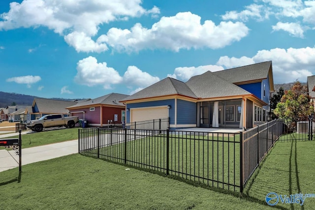 view of front of house featuring fence, concrete driveway, a front yard, a sunroom, and an attached garage