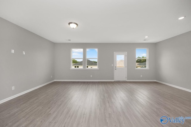 unfurnished room featuring hardwood / wood-style floors