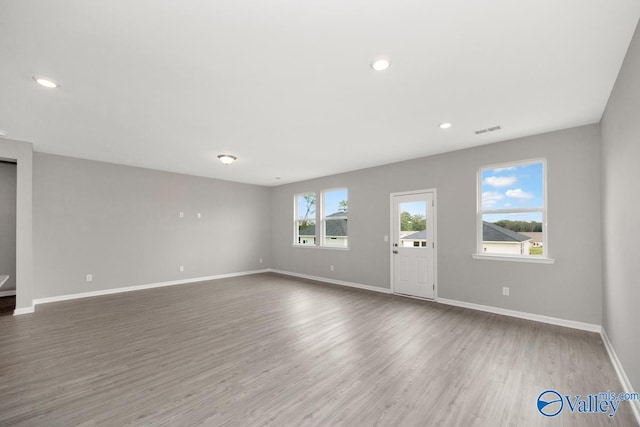 unfurnished living room with hardwood / wood-style floors