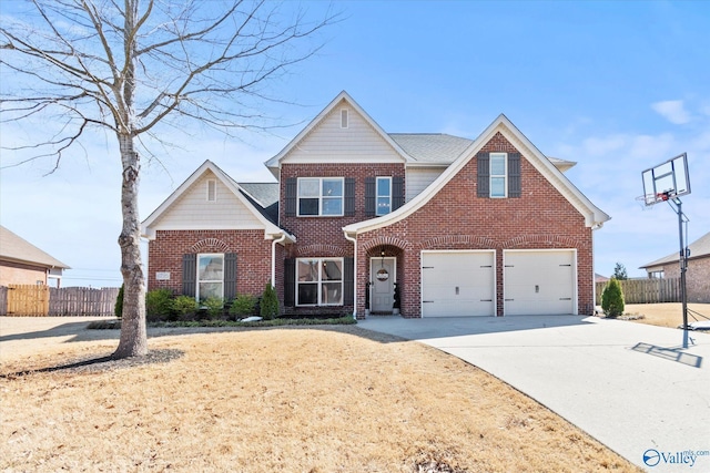 traditional home featuring an attached garage, fence, concrete driveway, and brick siding