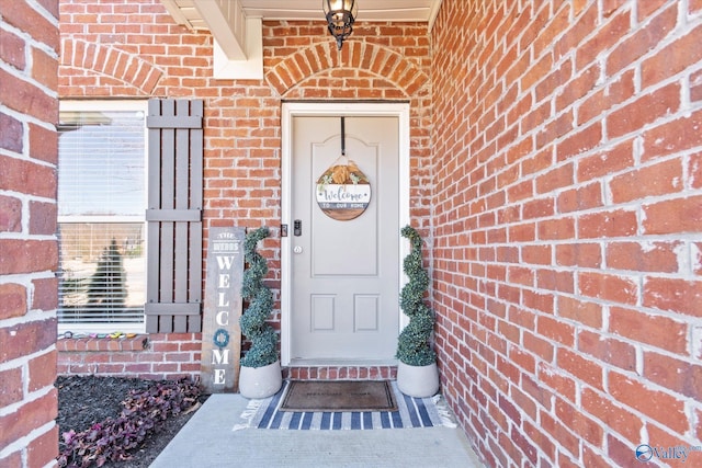 entrance to property with brick siding