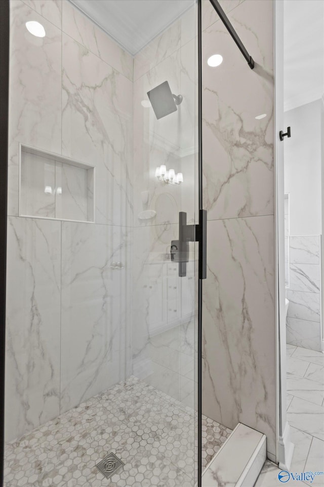 full bath with a marble finish shower and tile walls