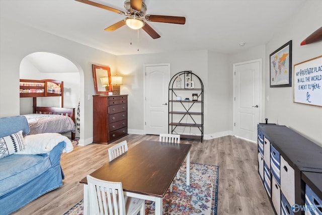 bedroom featuring a ceiling fan, light wood-type flooring, and baseboards