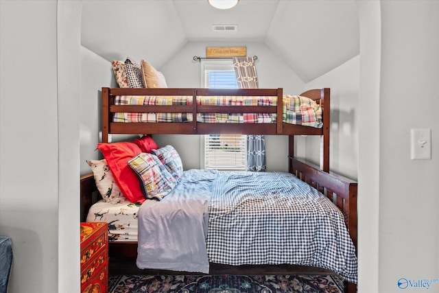 bedroom with visible vents and vaulted ceiling