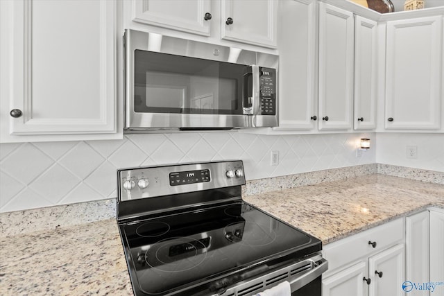 kitchen with white cabinetry, appliances with stainless steel finishes, and decorative backsplash