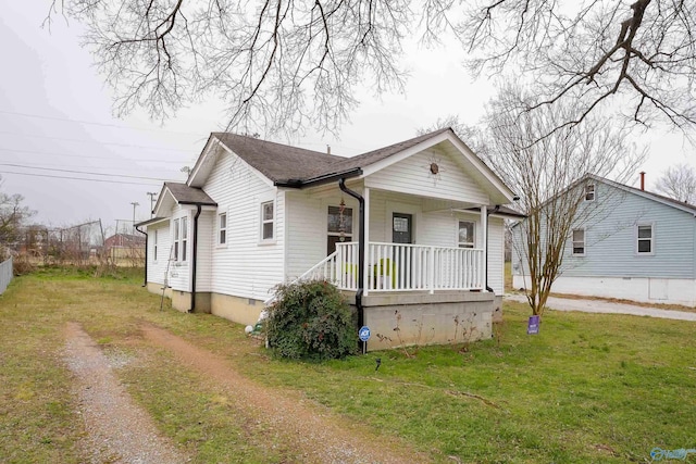 bungalow-style house featuring a porch, driveway, crawl space, roof with shingles, and a front lawn