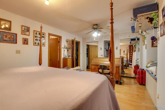 bedroom with ceiling fan, a textured ceiling, and light hardwood / wood-style floors