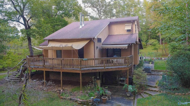 back of property featuring a deck and central AC unit