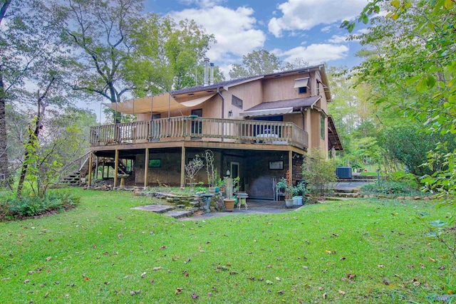 rear view of property featuring central AC, a deck, and a lawn