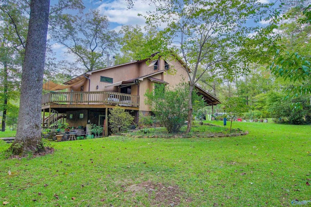 back of property featuring a deck and a yard