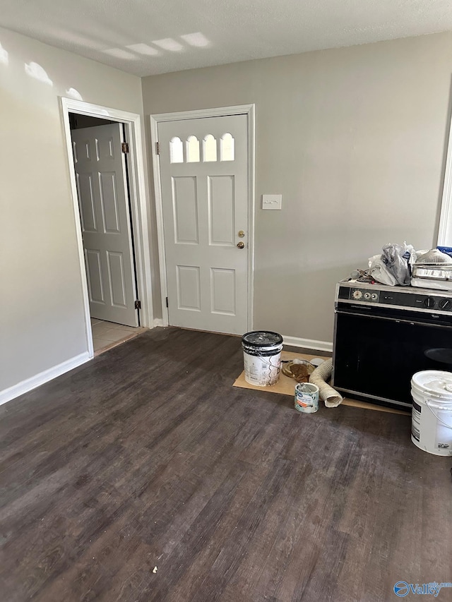 foyer featuring dark hardwood / wood-style floors and a textured ceiling