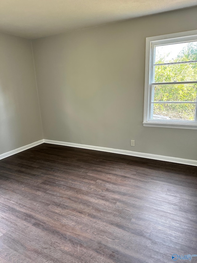 spare room featuring dark hardwood / wood-style floors