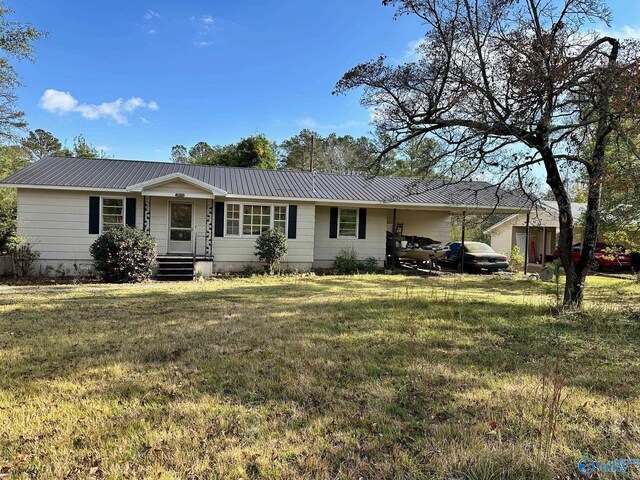 ranch-style home featuring a carport and a front lawn