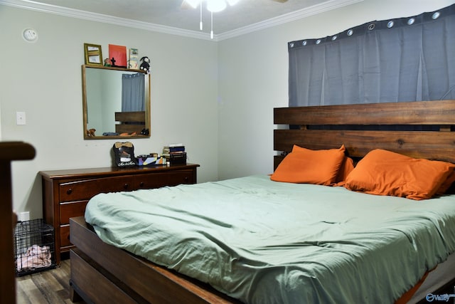 bedroom with crown molding and wood finished floors
