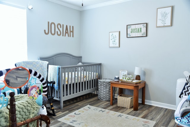 bedroom featuring wood finished floors, baseboards, and ornamental molding