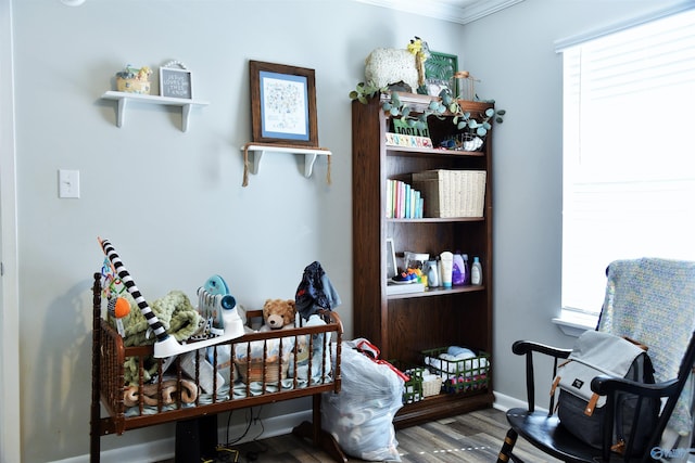 living area featuring baseboards and wood finished floors
