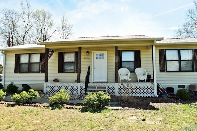 view of front of property featuring crawl space, a porch, and metal roof