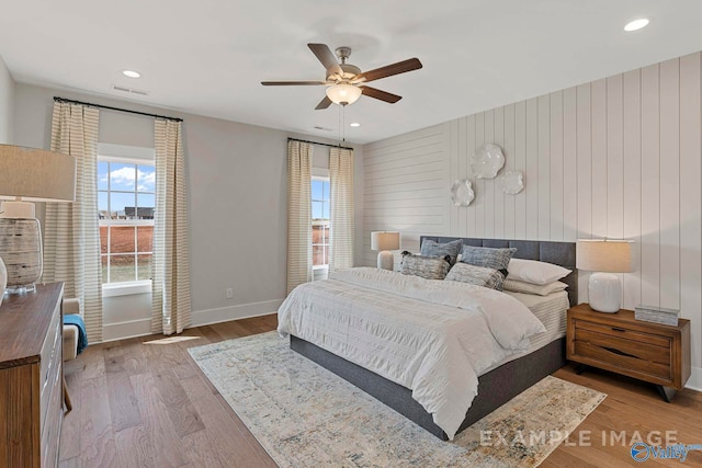 bedroom featuring recessed lighting, wood finished floors, visible vents, a ceiling fan, and baseboards