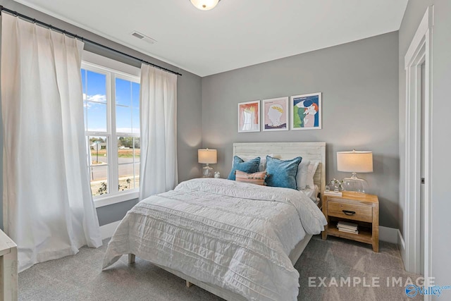 bedroom featuring carpet, visible vents, and baseboards