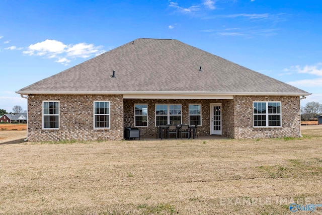 rear view of house featuring a patio and a yard