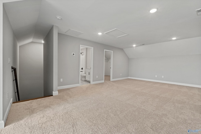 bonus room with recessed lighting, light colored carpet, baseboards, vaulted ceiling, and attic access