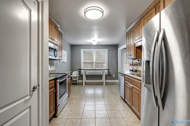 kitchen featuring light tile patterned floors and appliances with stainless steel finishes