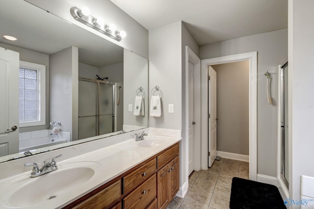 bathroom featuring tile patterned flooring, shower with separate bathtub, and vanity