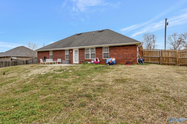 rear view of house with a lawn