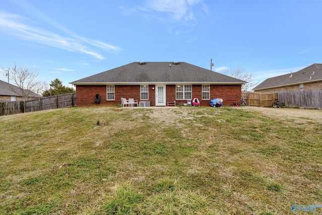 rear view of house with a patio and a lawn