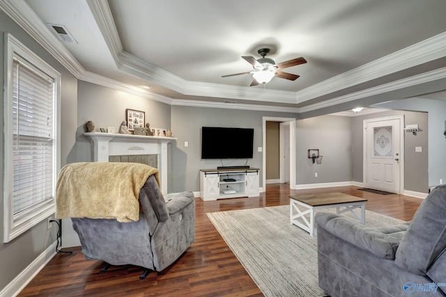 living room featuring crown molding, ceiling fan, dark hardwood / wood-style flooring, and a raised ceiling