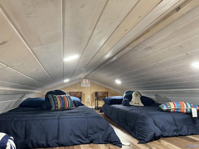 bedroom featuring wood-type flooring, wooden walls, vaulted ceiling, and wooden ceiling