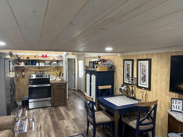 dining area featuring wood-type flooring, wooden walls, and wooden ceiling