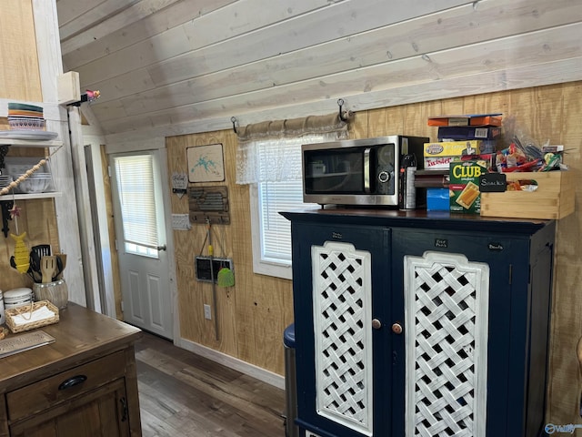 kitchen featuring wood ceiling, wooden walls, dark hardwood / wood-style floors, and vaulted ceiling