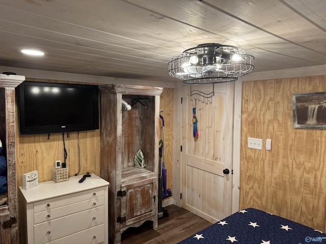 bedroom with dark hardwood / wood-style flooring, wood ceiling, and wooden walls