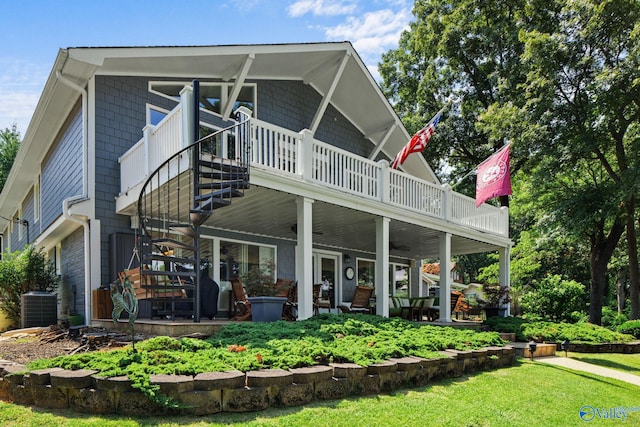 rear view of property featuring a yard, central AC unit, and a wooden deck