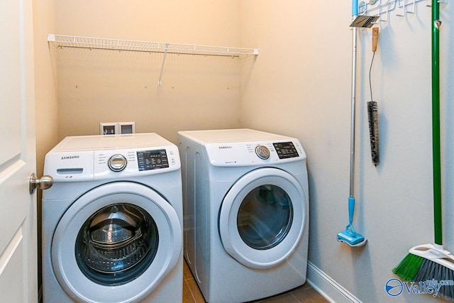 9 Leyland Dr SW, Huntsville, AL 35824 - washroom featuring tile patterned flooring, laundry area, baseboards, and washing machine and clothes dryer