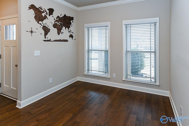 unfurnished room featuring ornamental molding, dark wood finished floors, and baseboards