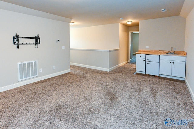 9 Leyland Dr SW, Huntsville, AL 35824 - carpeted empty room with baseboards, visible vents, and a sink