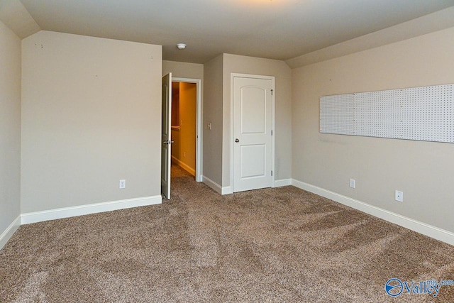 9 Leyland Dr SW, Huntsville, AL 35824 - carpeted spare room with vaulted ceiling and baseboards