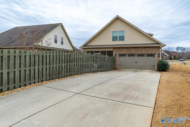 9 Leyland Dr SW, Huntsville, AL 35824 - view of front of home with concrete driveway, brick siding, fence, and an attached garage