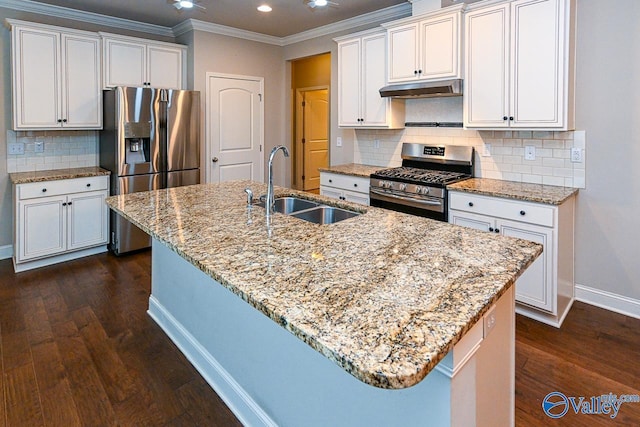 9 Leyland Dr SW, Huntsville, AL 35824 - kitchen with under cabinet range hood, a sink, white cabinets, appliances with stainless steel finishes, and an island with sink
