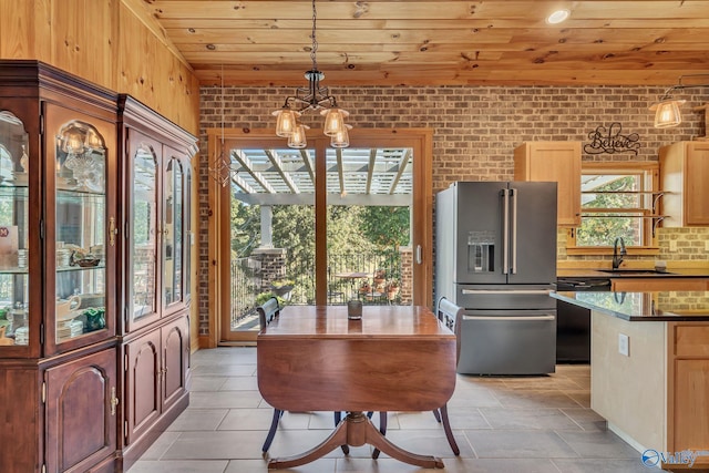 dining space with brick wall, sink, a notable chandelier, and wooden ceiling